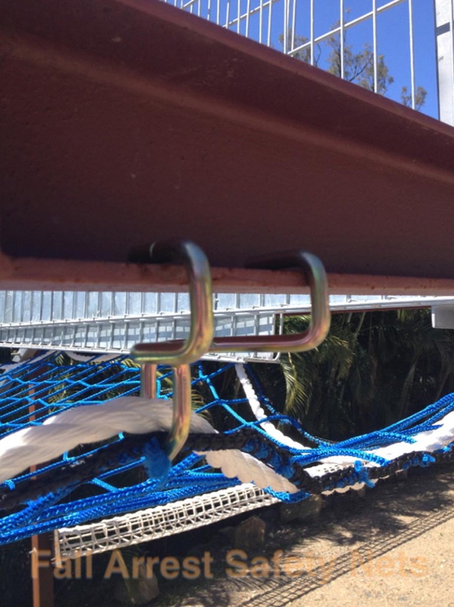 Net Claw used for installing safety netting in use on a steel beam.