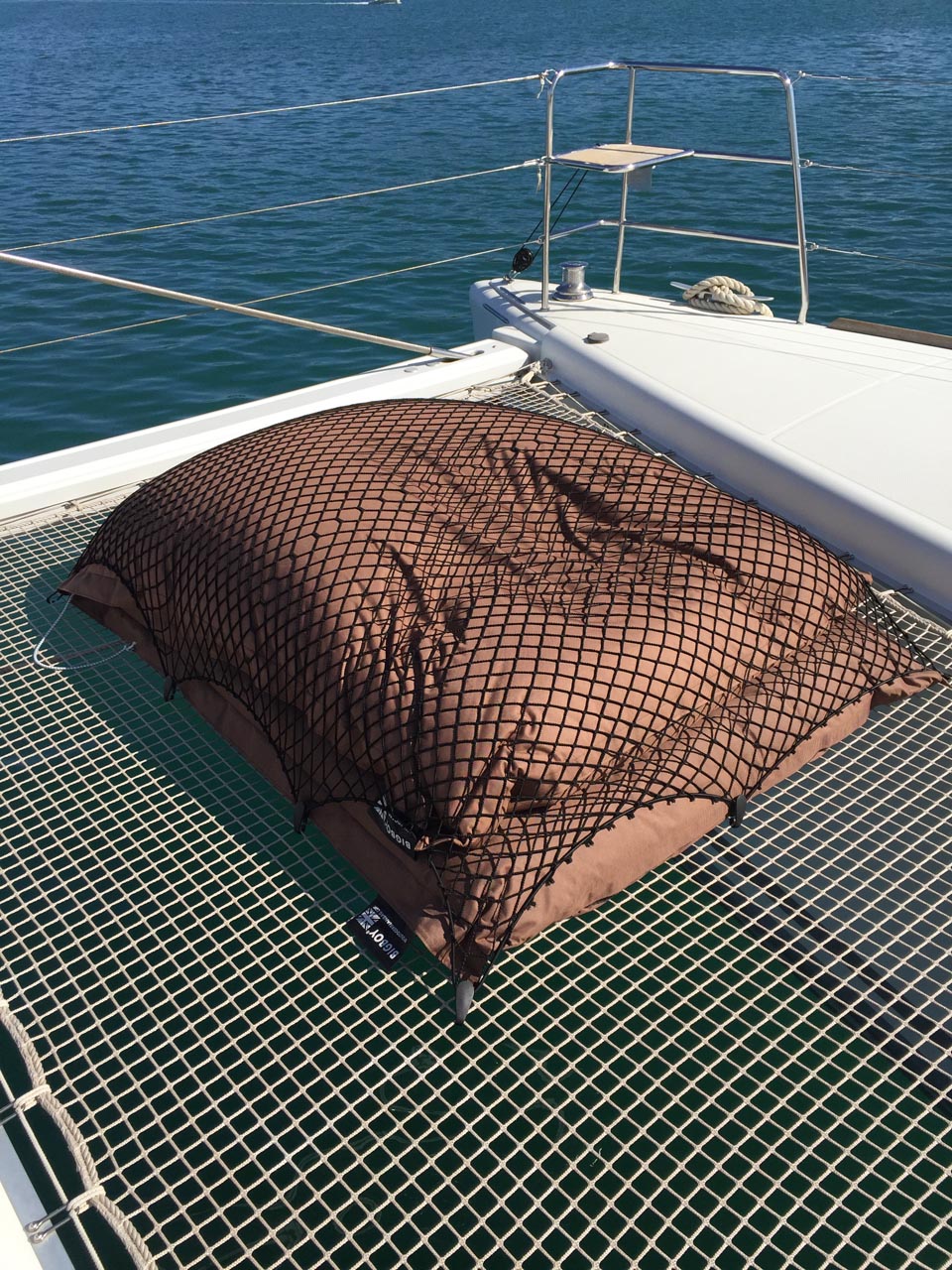 Bespoke elasticated net for covering cushions on a boat deck.