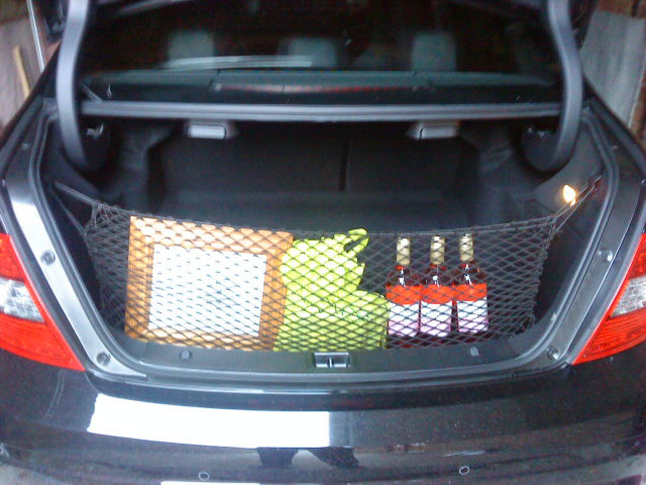 Elastic net in a car boot to help with the organisation and storage of groceries and other small items.
