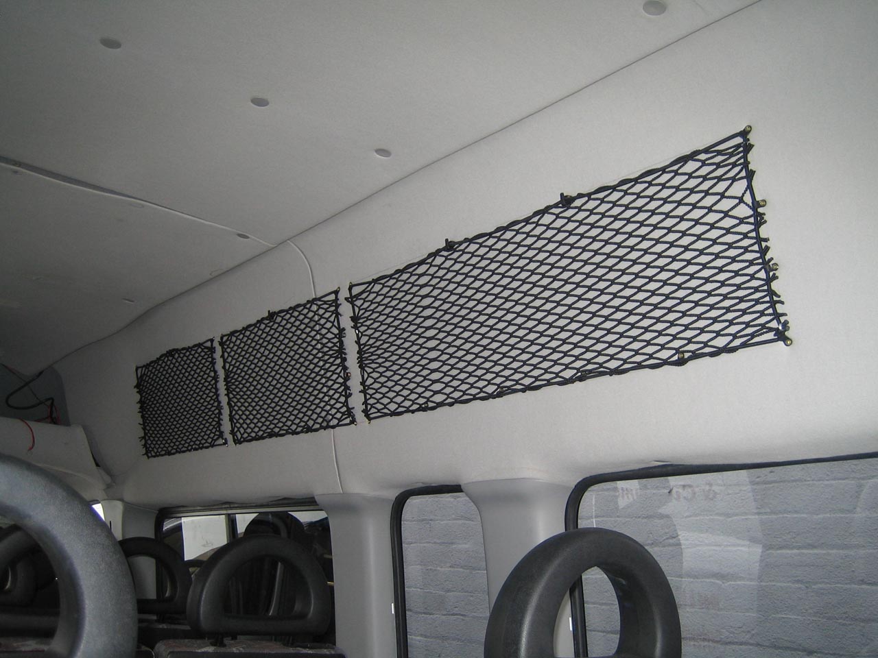 Bespoke elastic nets to create storage space on the inside of a van