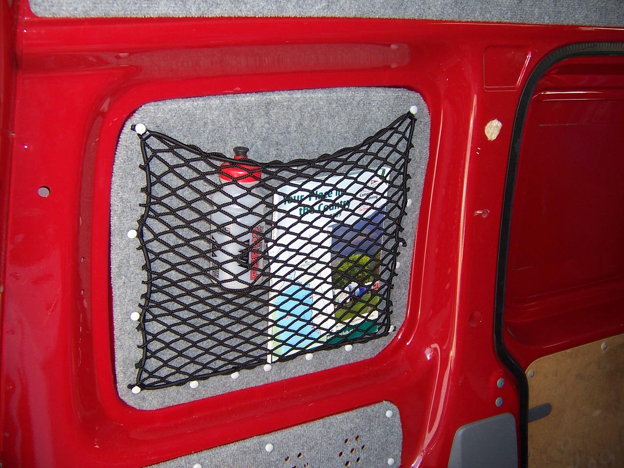 Bespoke elastic net showing items stored in a van