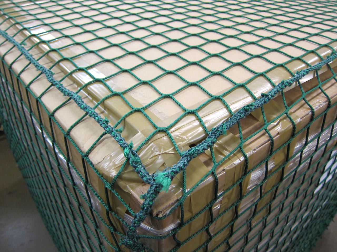 Close-up of dark green pallet cover net.