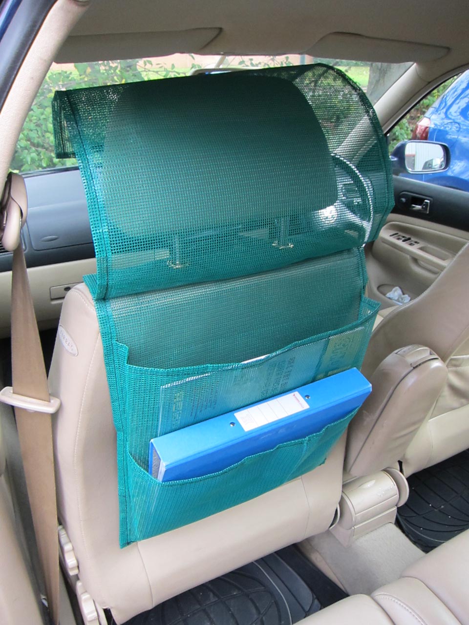 Open view of a bespoke green mesh document pocket organiser for use behind a car seat or in a commercial vehicle.
