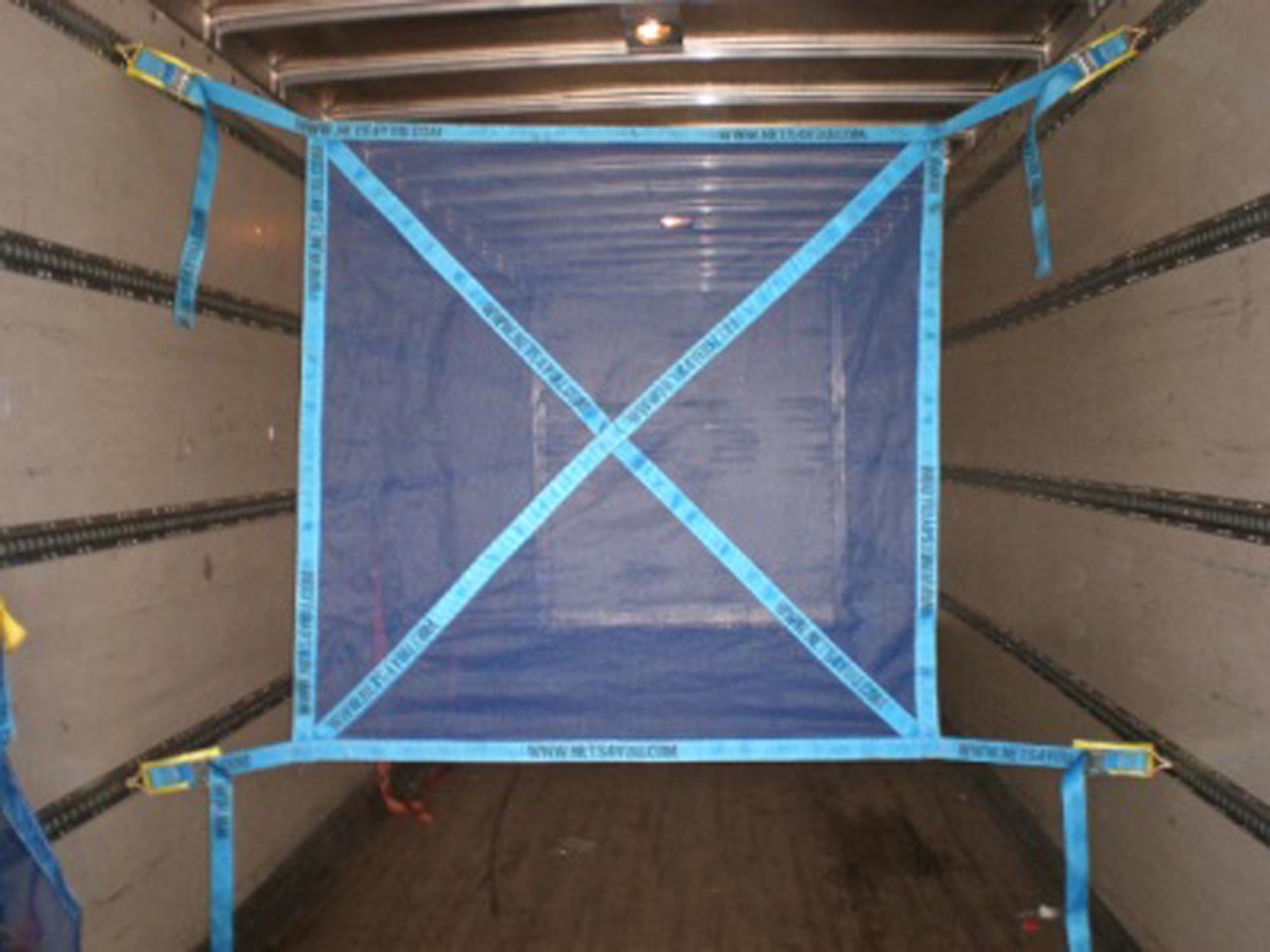 Load restraint net fitted in a vehicle.