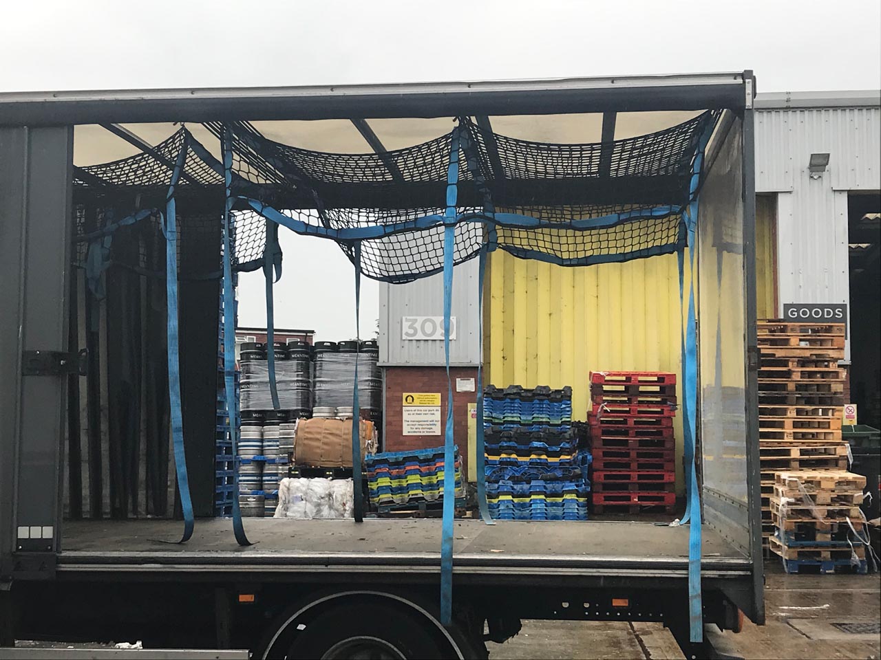 Load control nets with integrated fittings as part of a cargo load control system on a truck.