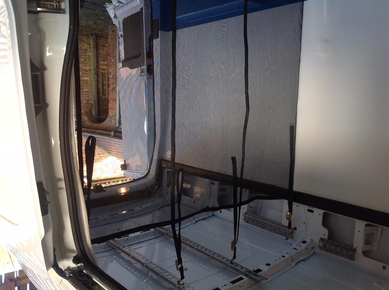 Black partition net fitted in the back of a truck