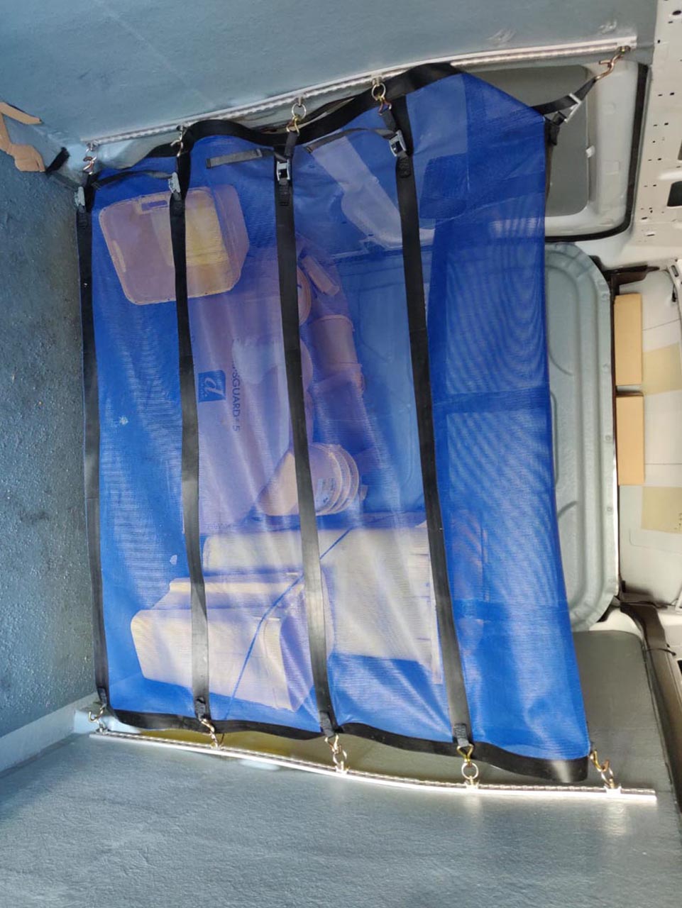 Blue partition net fitted in the back of a truck