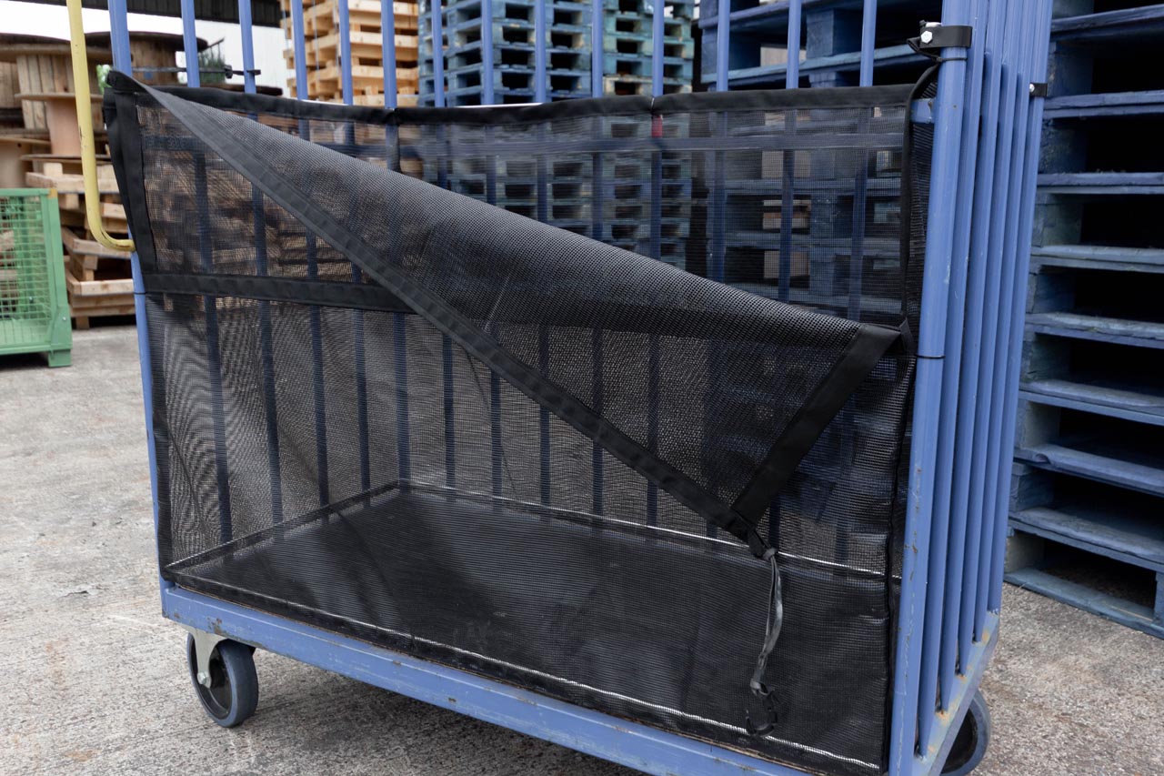 Bespoke roll cage trolley net with front flap partially opened.