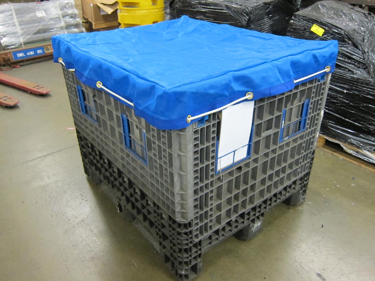 Blue mesh stillage cover with bungee cord