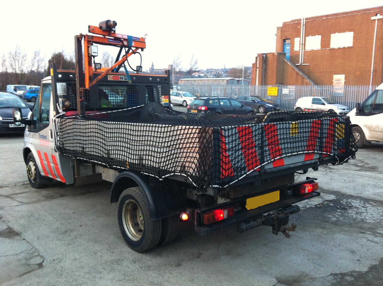 Cargo net covering a load on the back of a vehicle trailer