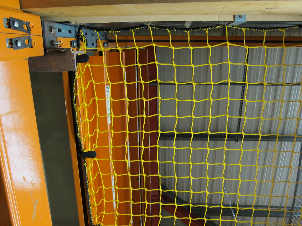 Close-up of yellow knotted netting in a warehouse.